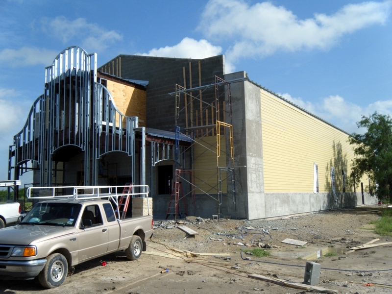 Steel-frame church addition under construction with scaffolding